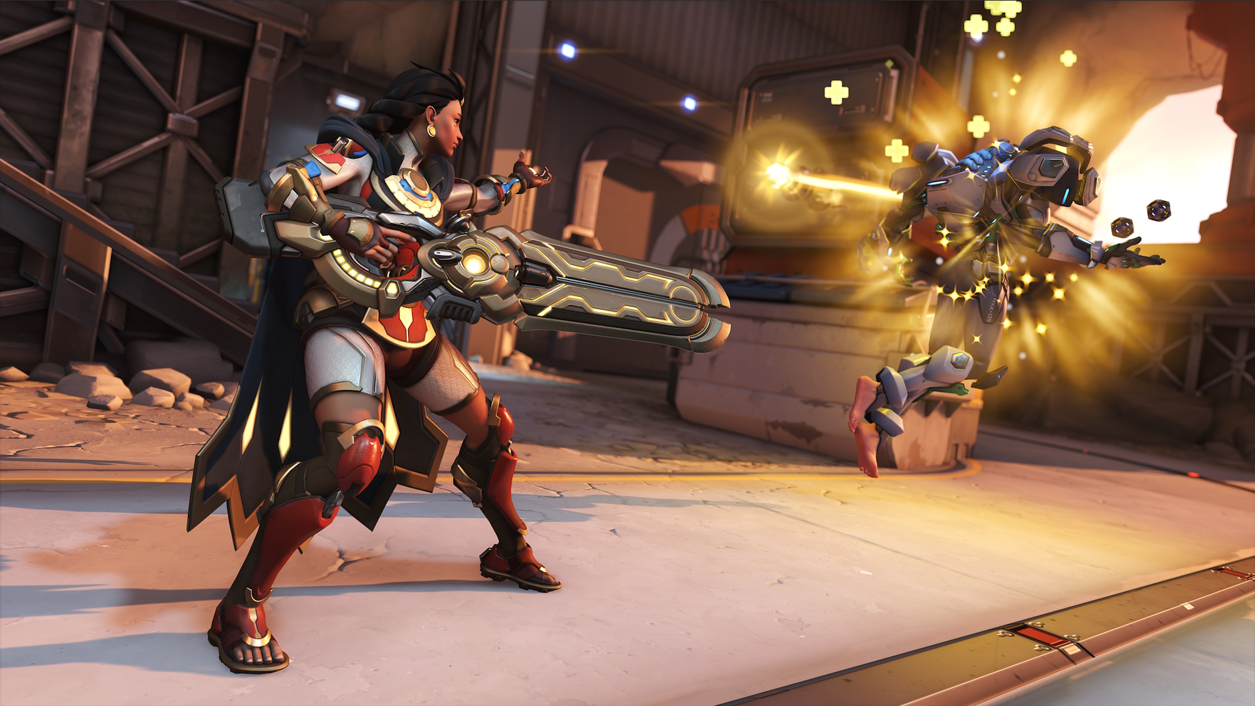 A young woman in scarlet and gold armor is sending healing light to a nearby robot. She holds a large rifle in her right hand
